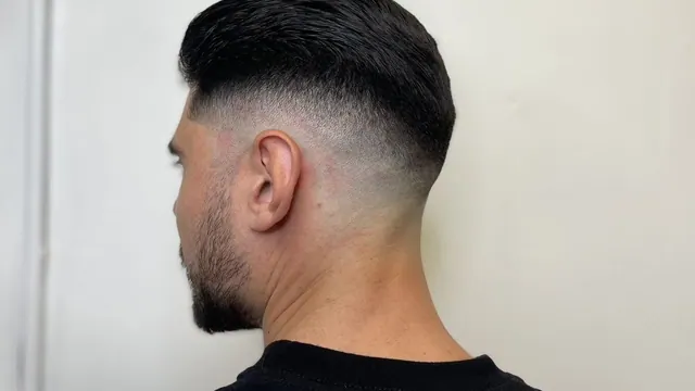 A slick top with a low skin fade