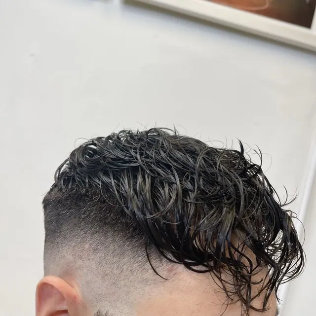 Wavy length on top with a skin fade